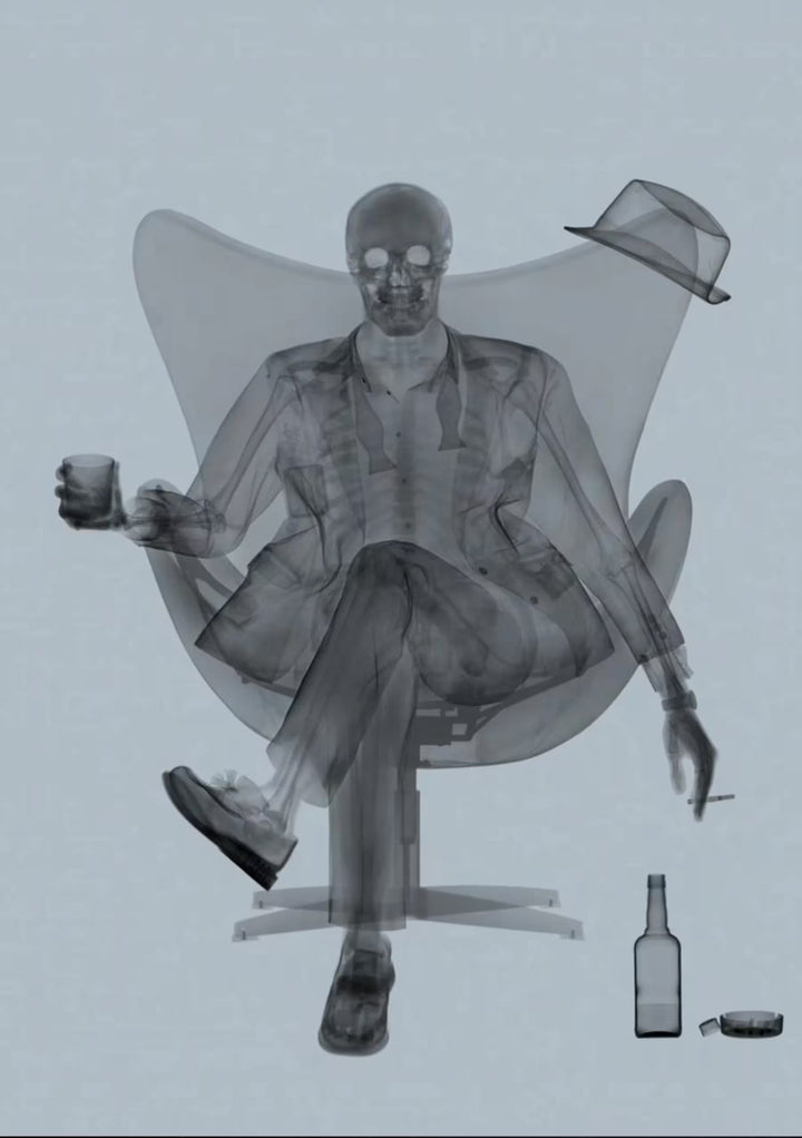 A limited edition Chromaluxe print by Nick Veasey of an X-Rayed ratpack member sat on a big chair with a drink in their hand, the title is Rat Pack Grey