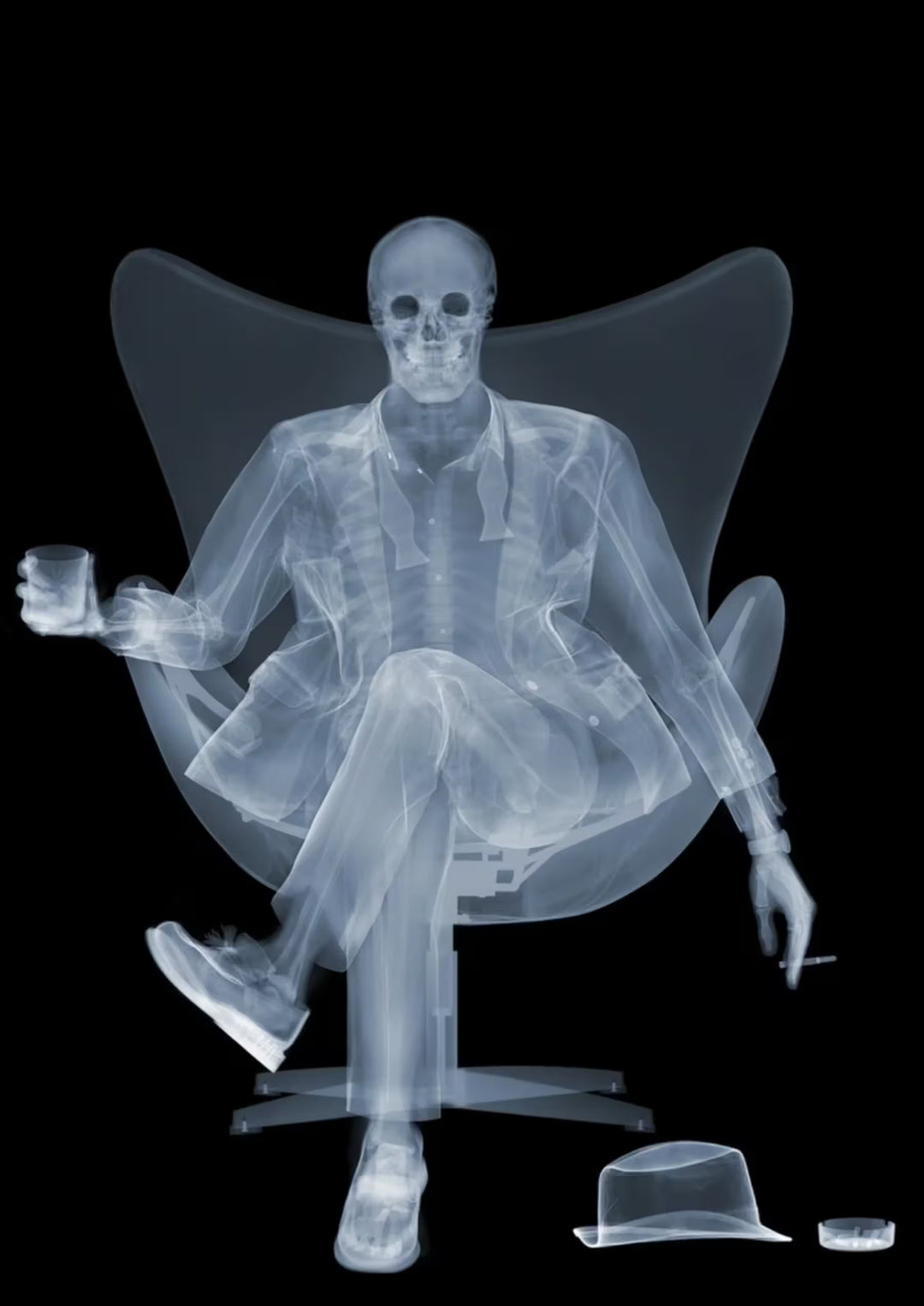 A limited edition Chromaluxe print by Nick Veasey of an X-Rayed ratpack member sat on a big chair with a drink in their hand, the title is Rat Pack