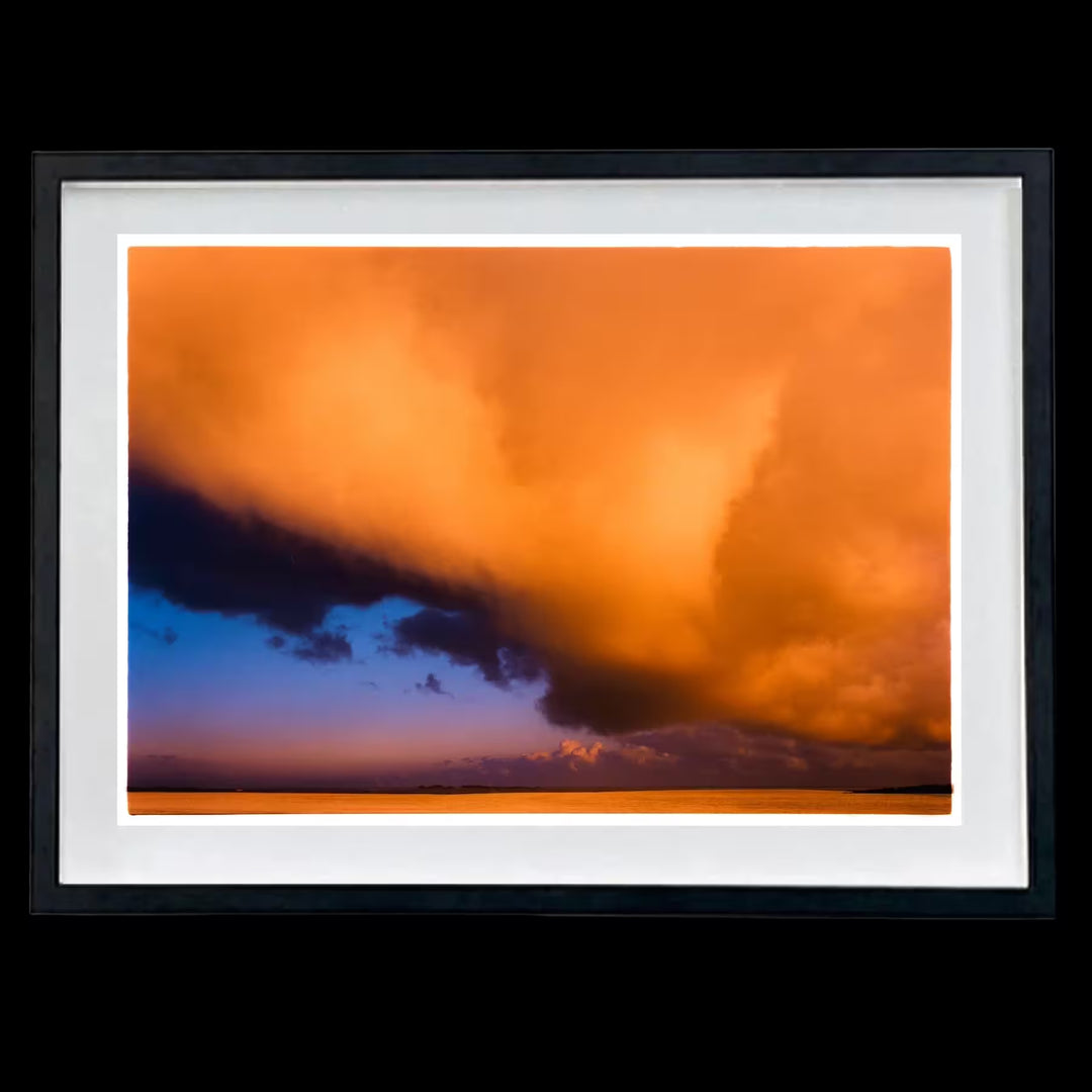 A framed limited edition photograph by Richard Heeps using vibrant colours, the title is Red Clouds, Wells-Next-The-Sea, Norfolk, 2003