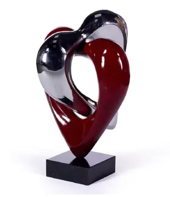 A Jennine Parker limited edition sculpture of two hearts linked together, the title is Sacred Hearts