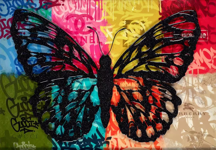 A Dan Pearce limited edition piece of a background with different fashion labels on with a black glittery butterfly over the top, the title is Wings of Love